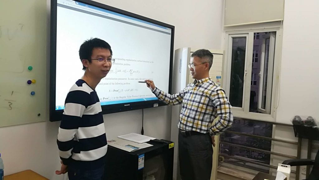 Fig. 3. Discussing with Professor Peng in his office.